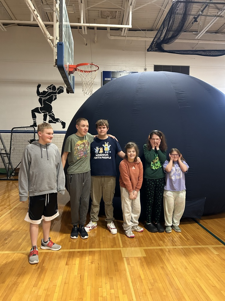 students outside of blow up planetarium