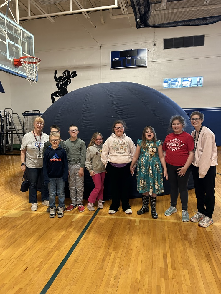 students outside of blow up planetarium