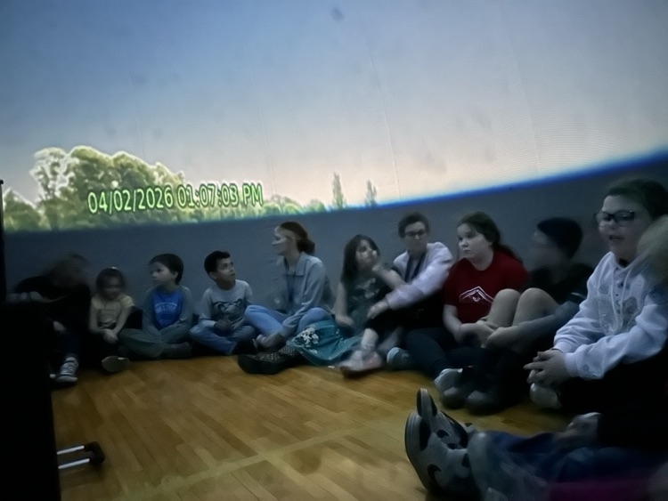 students inside of blow up planetarium