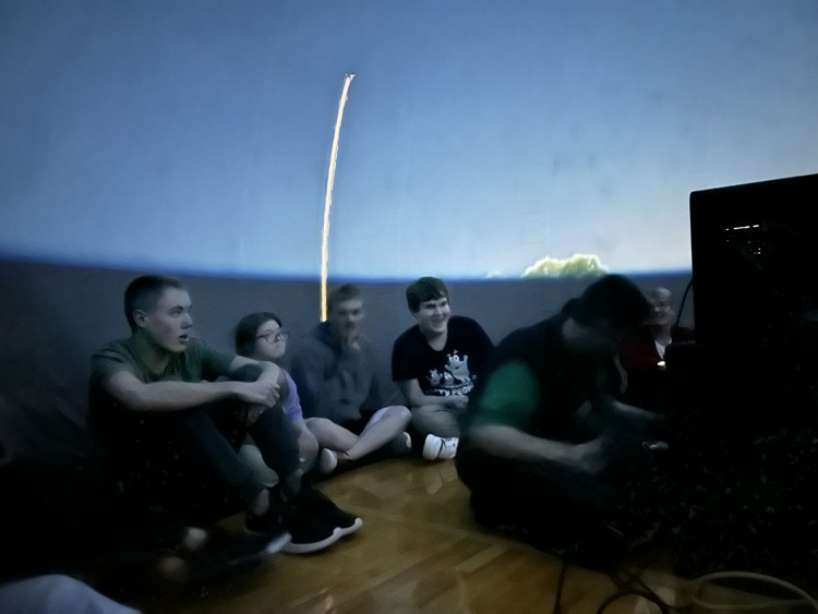 students inside of blow up planetarium