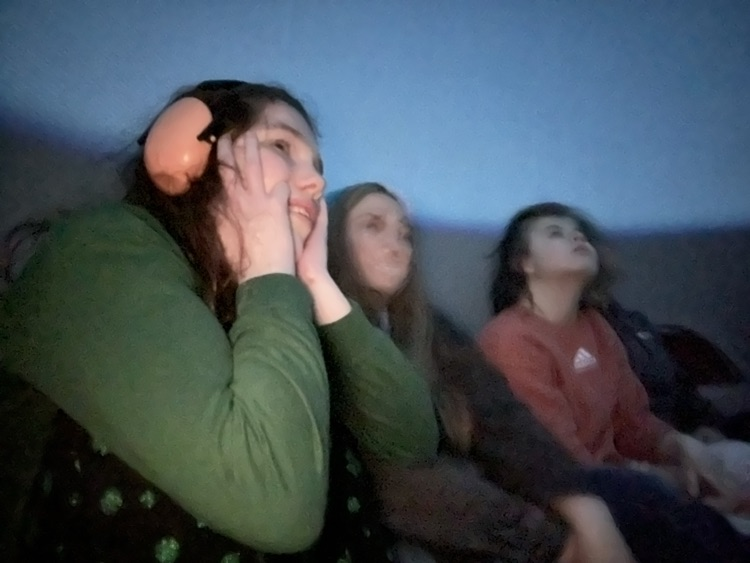 students inside of blow up planetarium