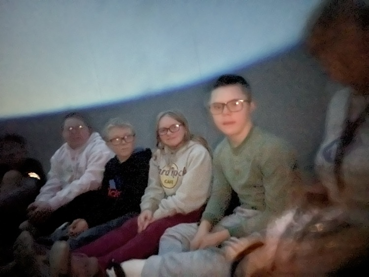 students inside of blow up planetarium