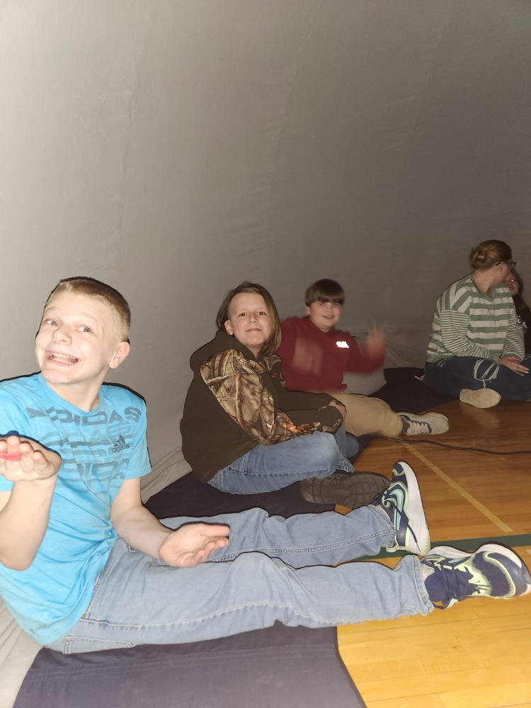 students inside of blow up planetarium