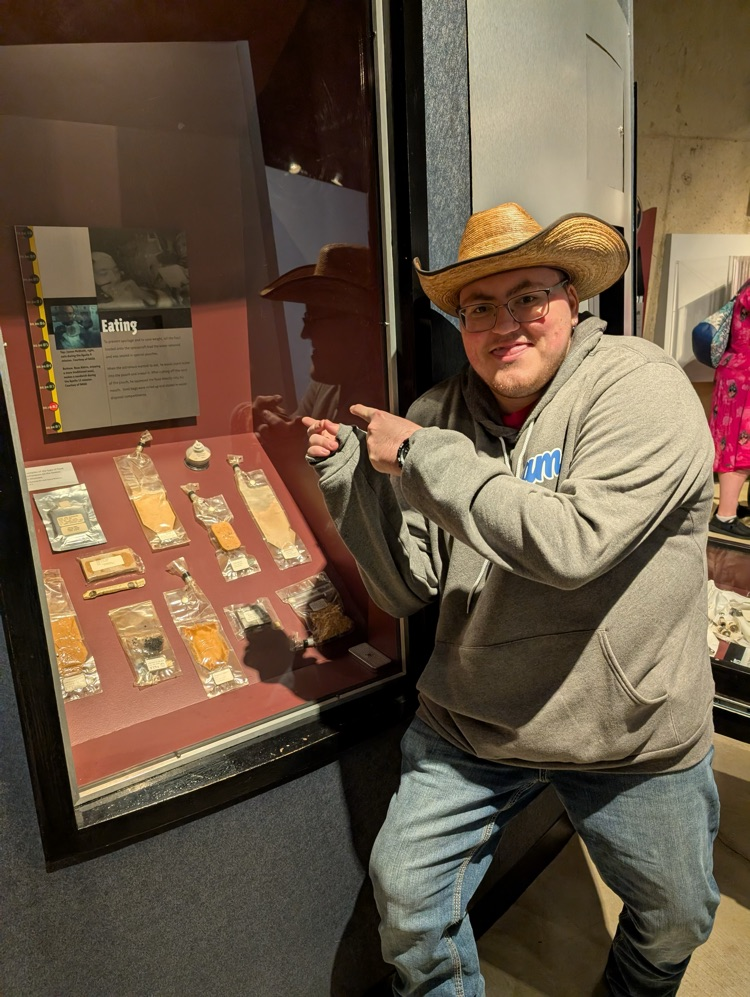 student pointing at space food