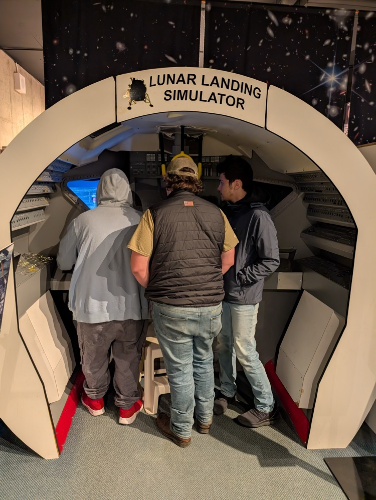 students watching lunar landing simulator