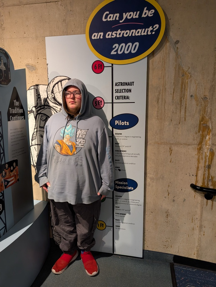 student measuring up to sign