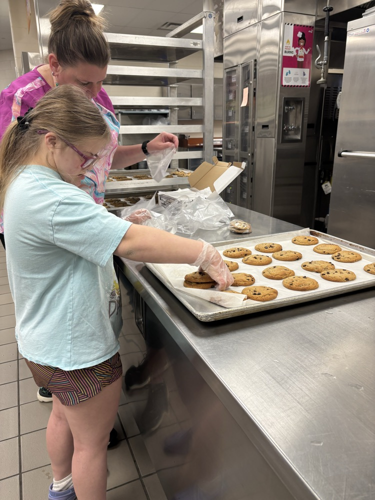 student helping to bake cookies