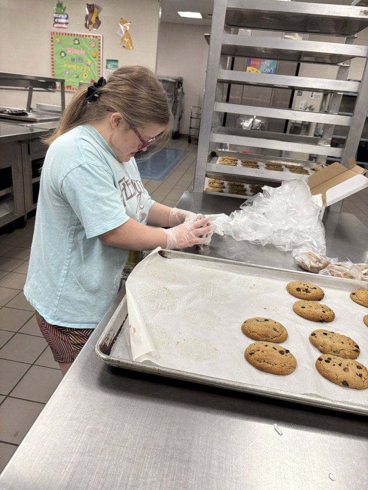 student helping to bake cookies