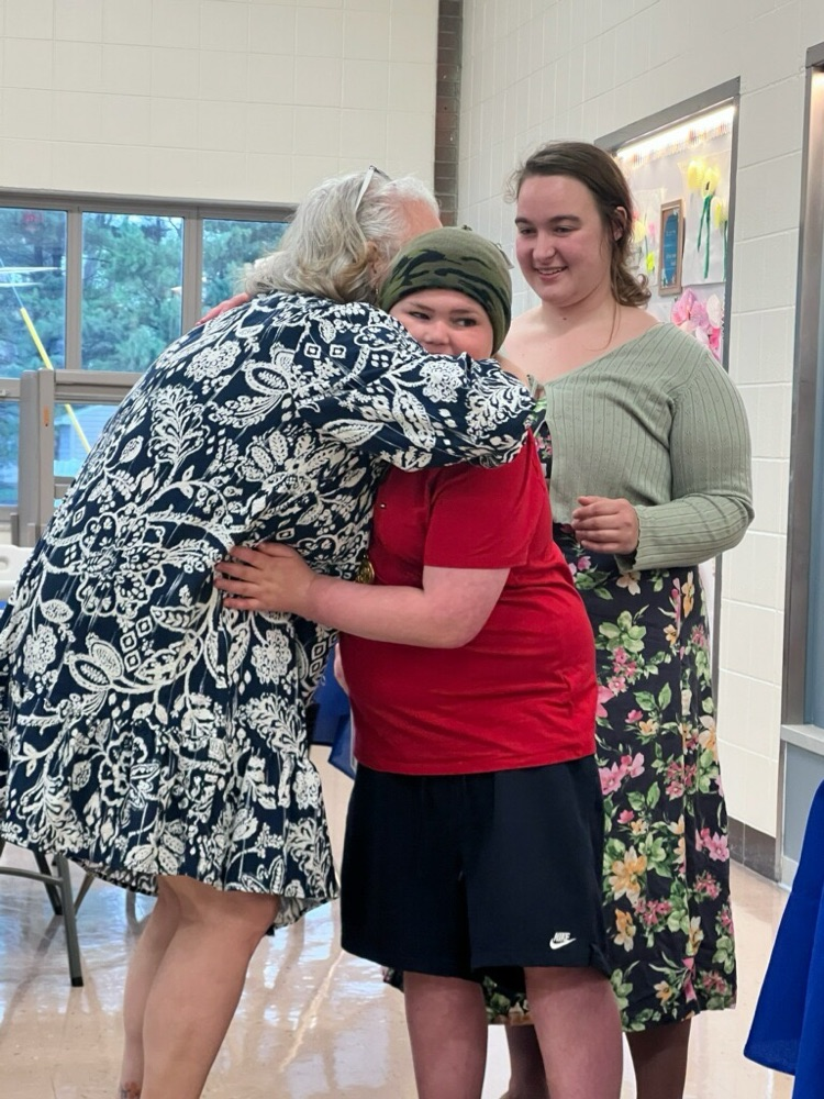 student hugging principal