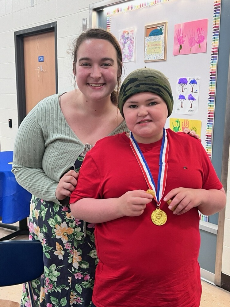 student standing with teacher