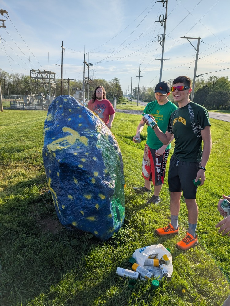 students painting rock
