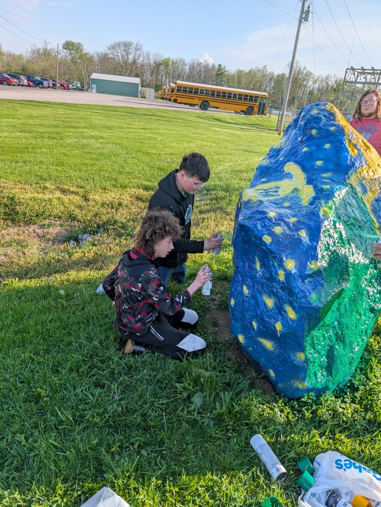 students painting rock