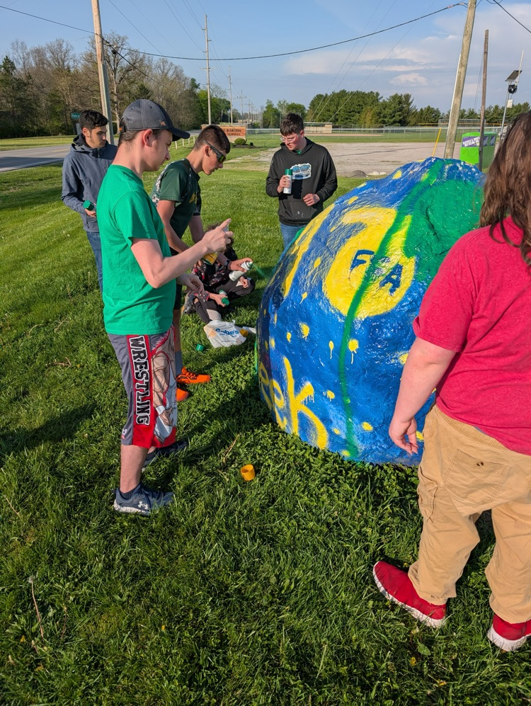 students painting rock