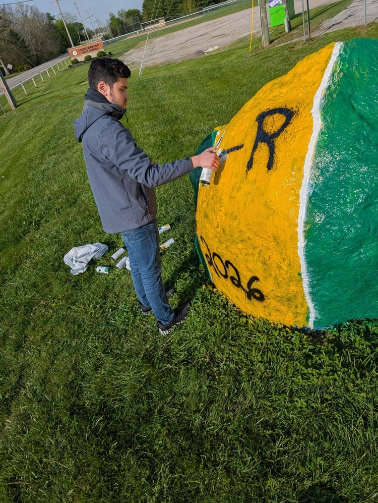 students painting rock