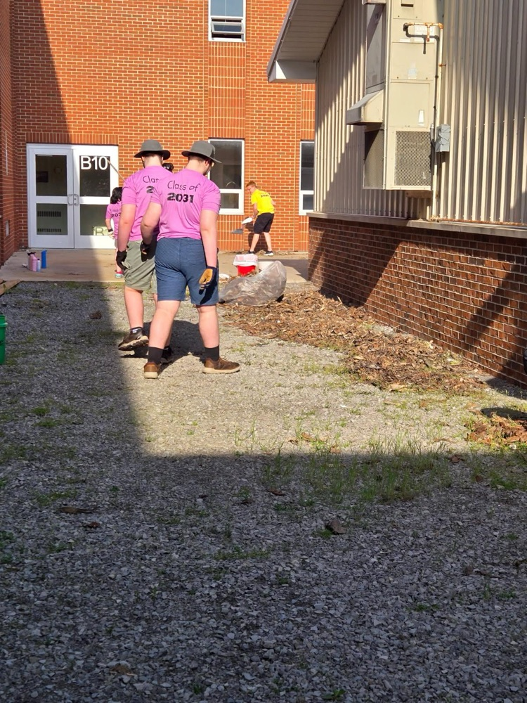class cleaning up leaves