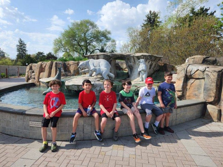 students in front of fountain