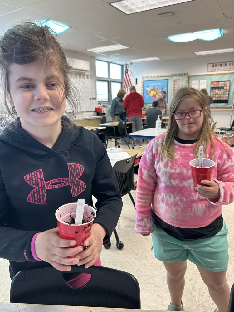 students with soil cups