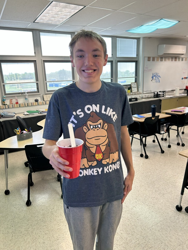 student with soil cup
