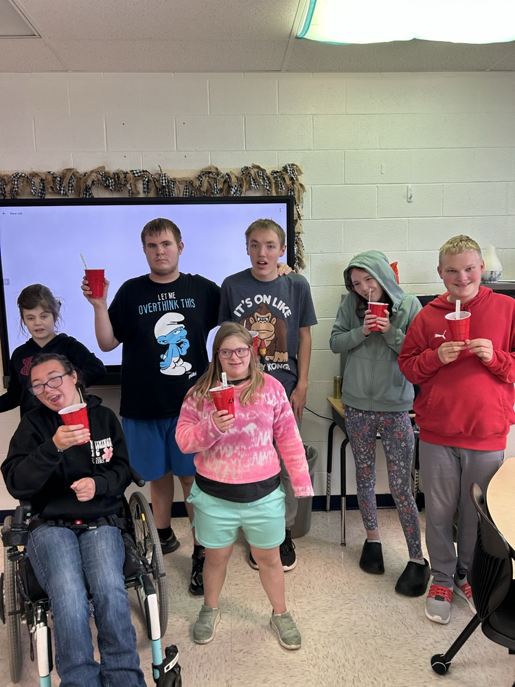 students with soil cups