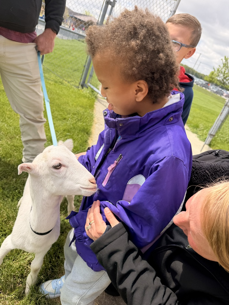 student petting goat