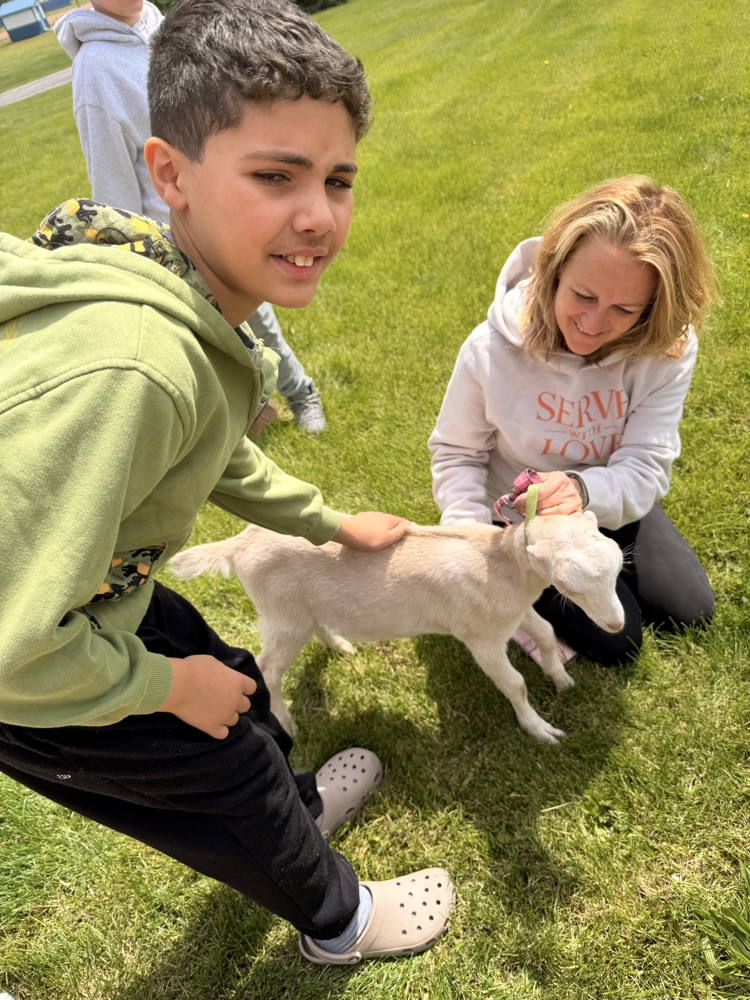 student petting goat