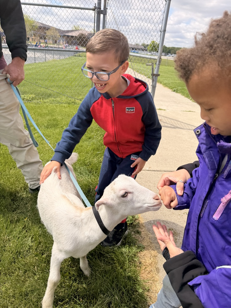 student petting goat