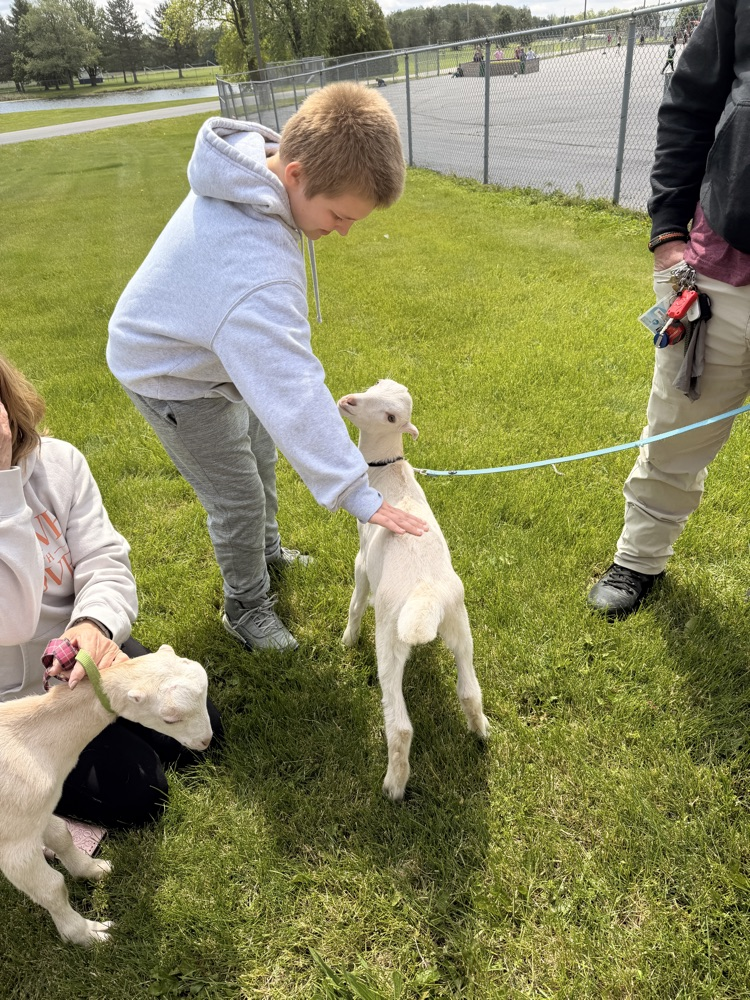 student petting goat