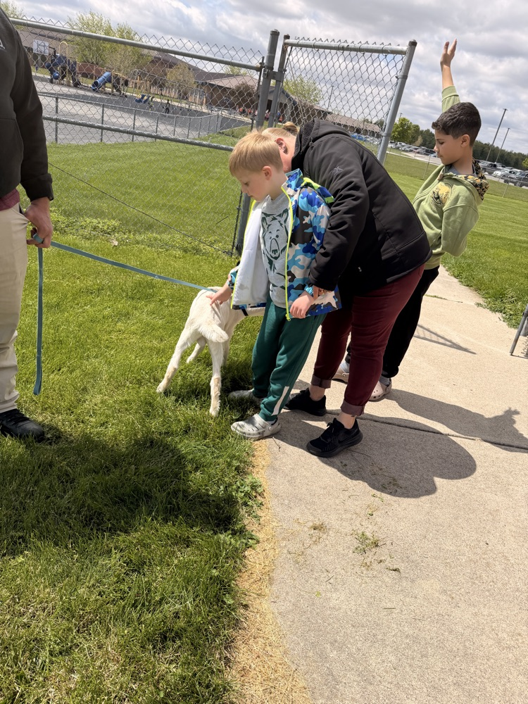 student petting goat