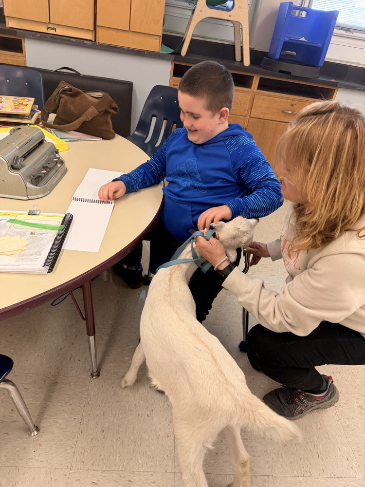 student petting goat