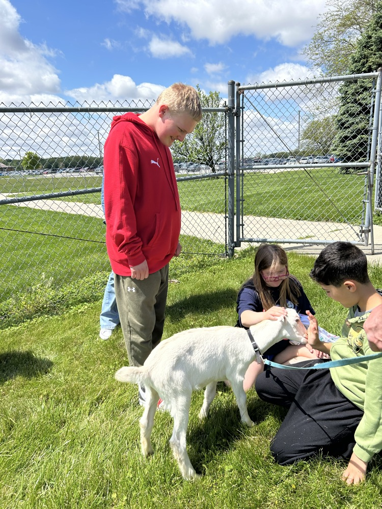 student petting goat