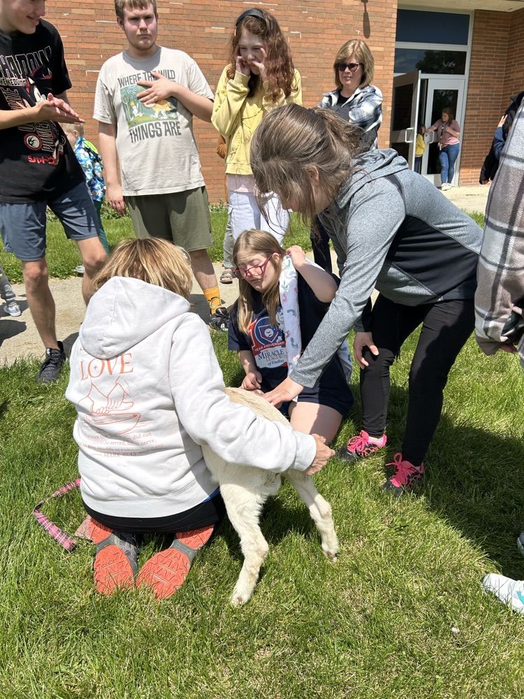 student petting goat