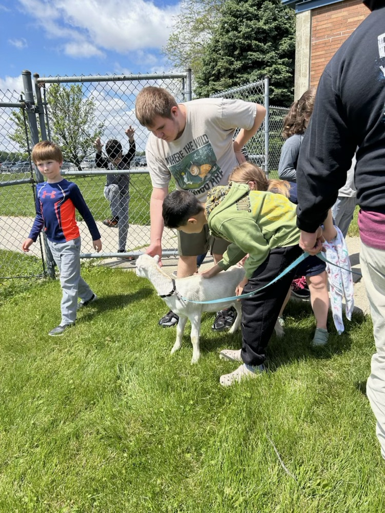 student petting goat