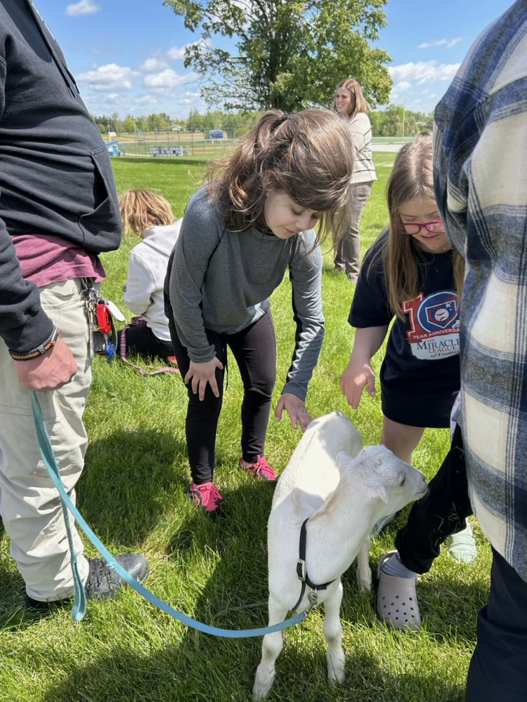 student petting goat
