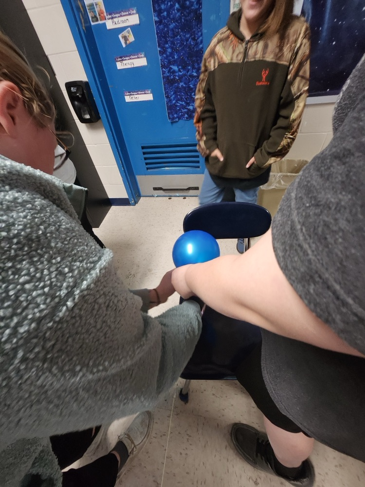 teachers blowing up balloons