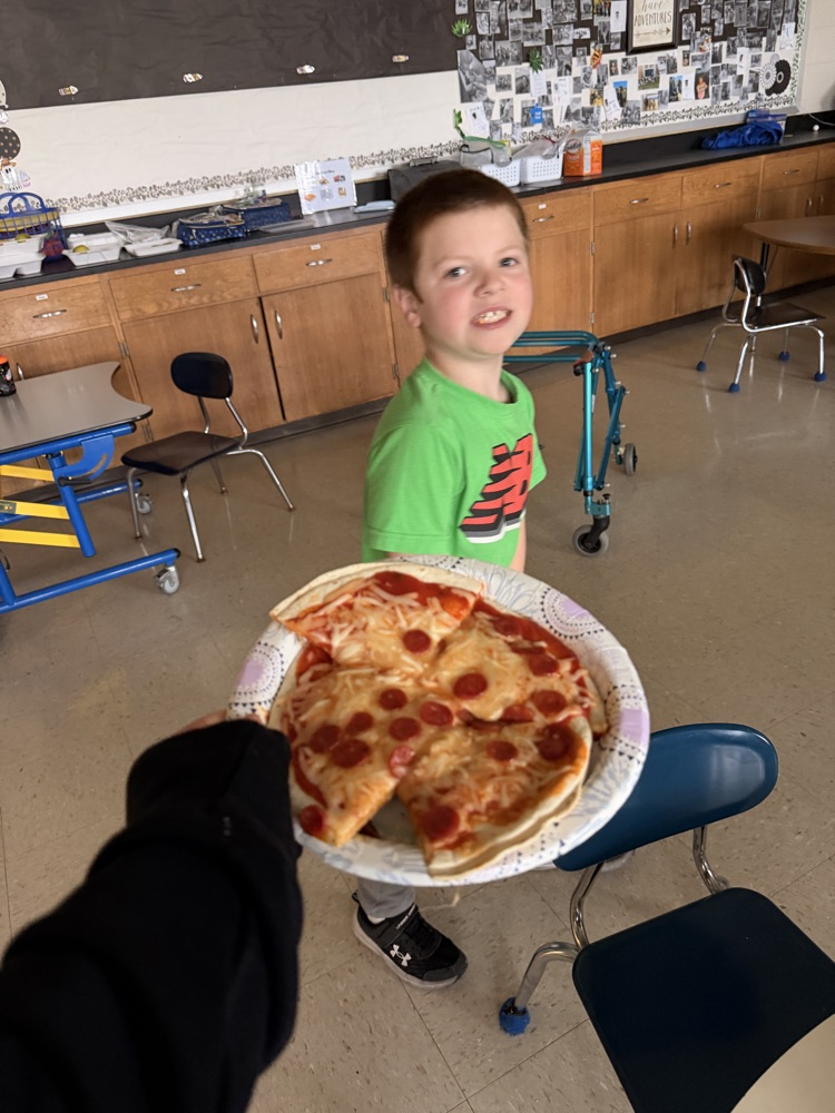 student with the pizza they made