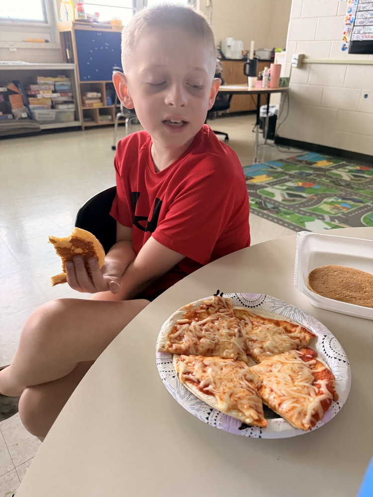 student with the pizza they made