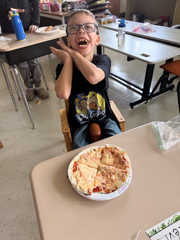 student with the pizza they made