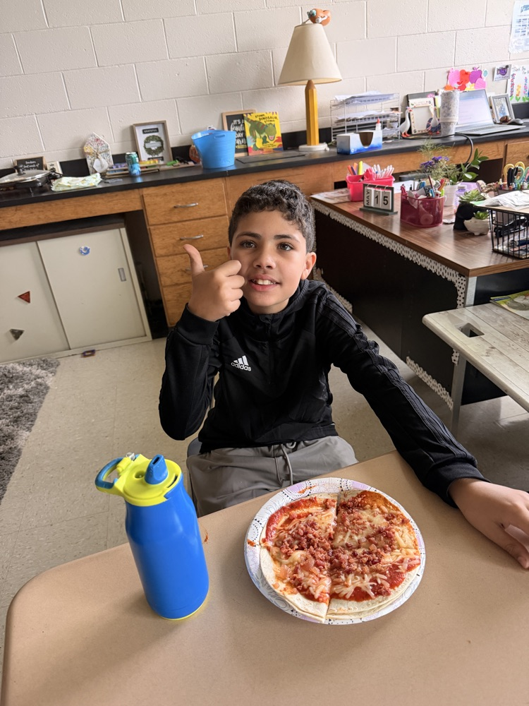 student with the pizza they made