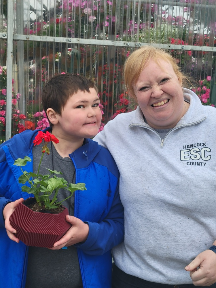 teacher and boy with flowers