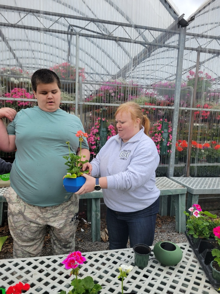 teacher and boy with flowers