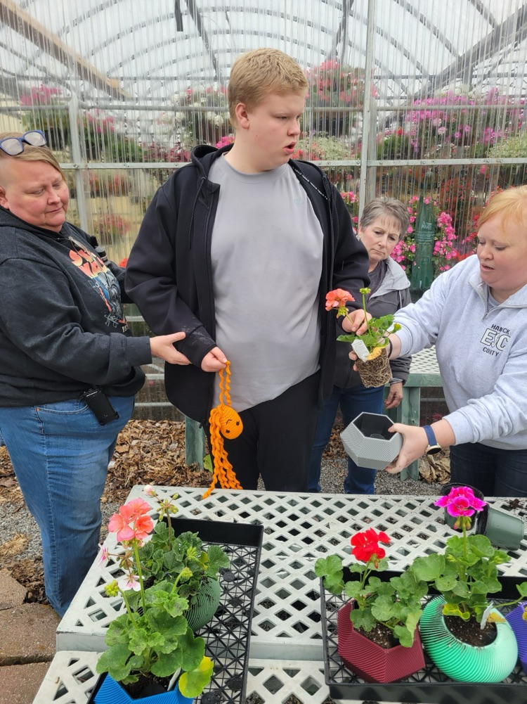 teachers and boy with flowers