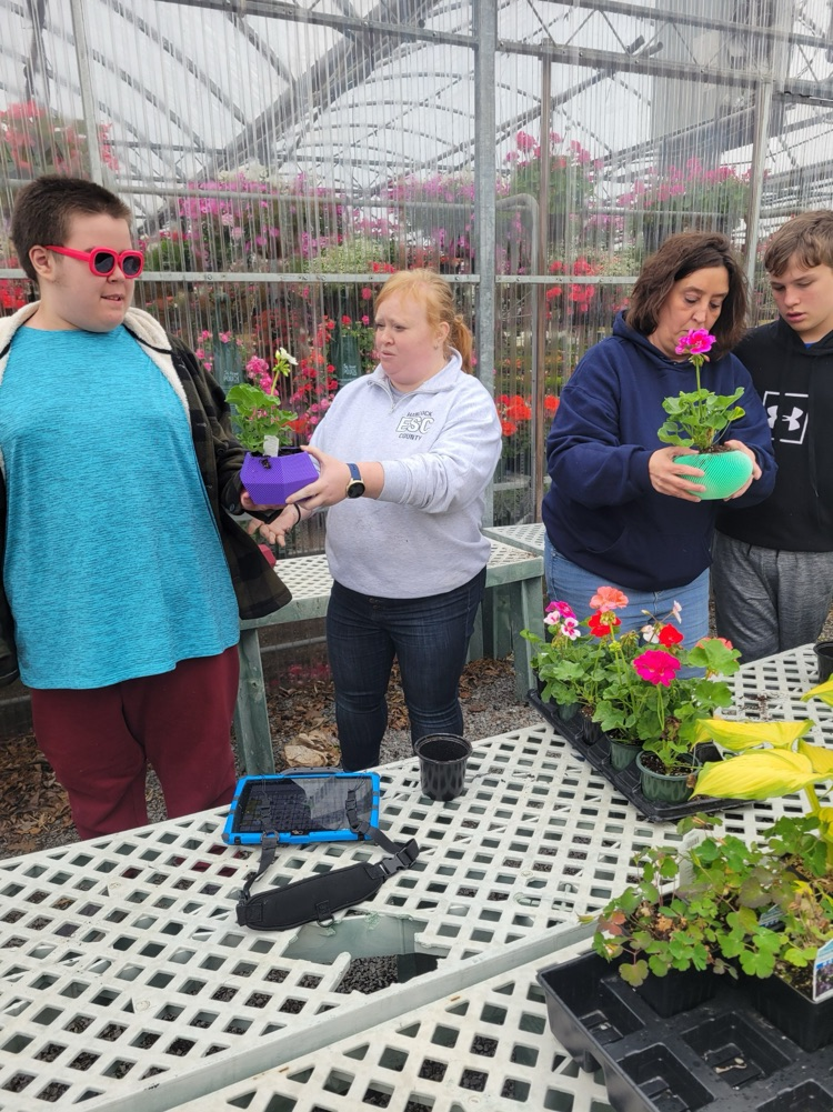 teachers and boy with flowers