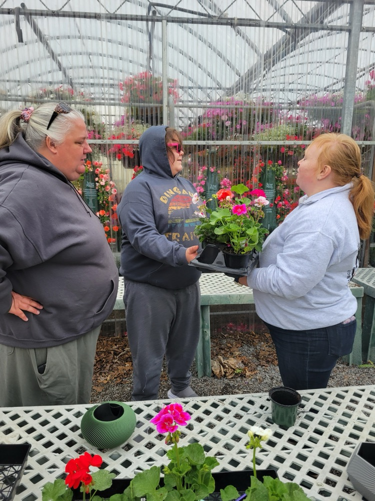 teachers and boy with flowers