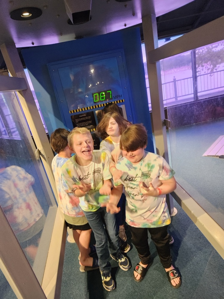 students in a wind simulation