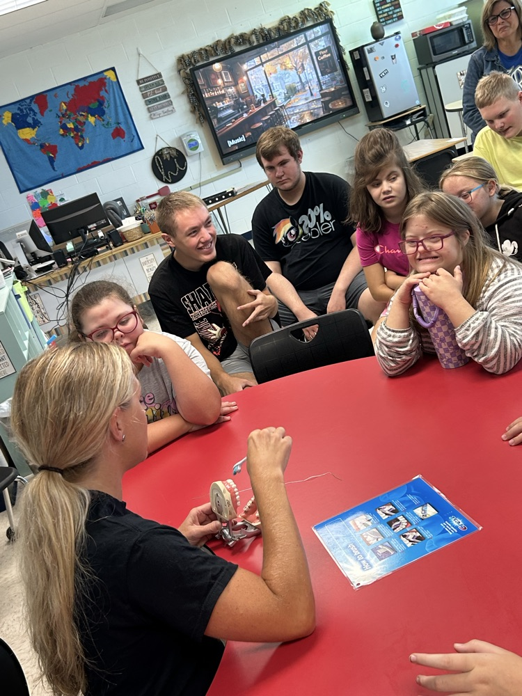 students watching demonstration from dental hygienist