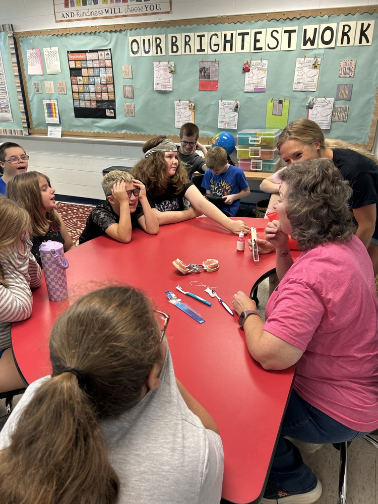 teacher scrubbing teeth