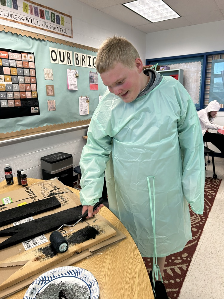 student painting wood