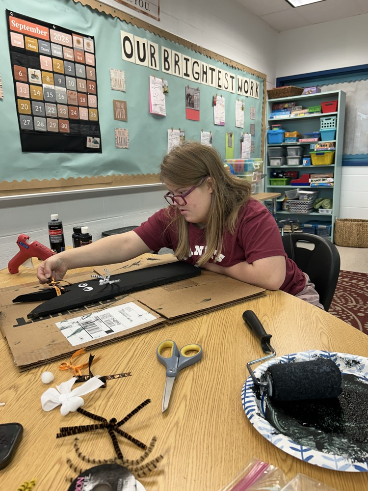 student crafting with wood