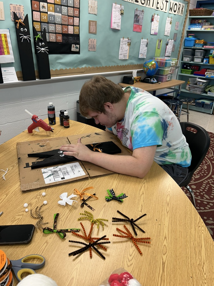 student crafting with wood