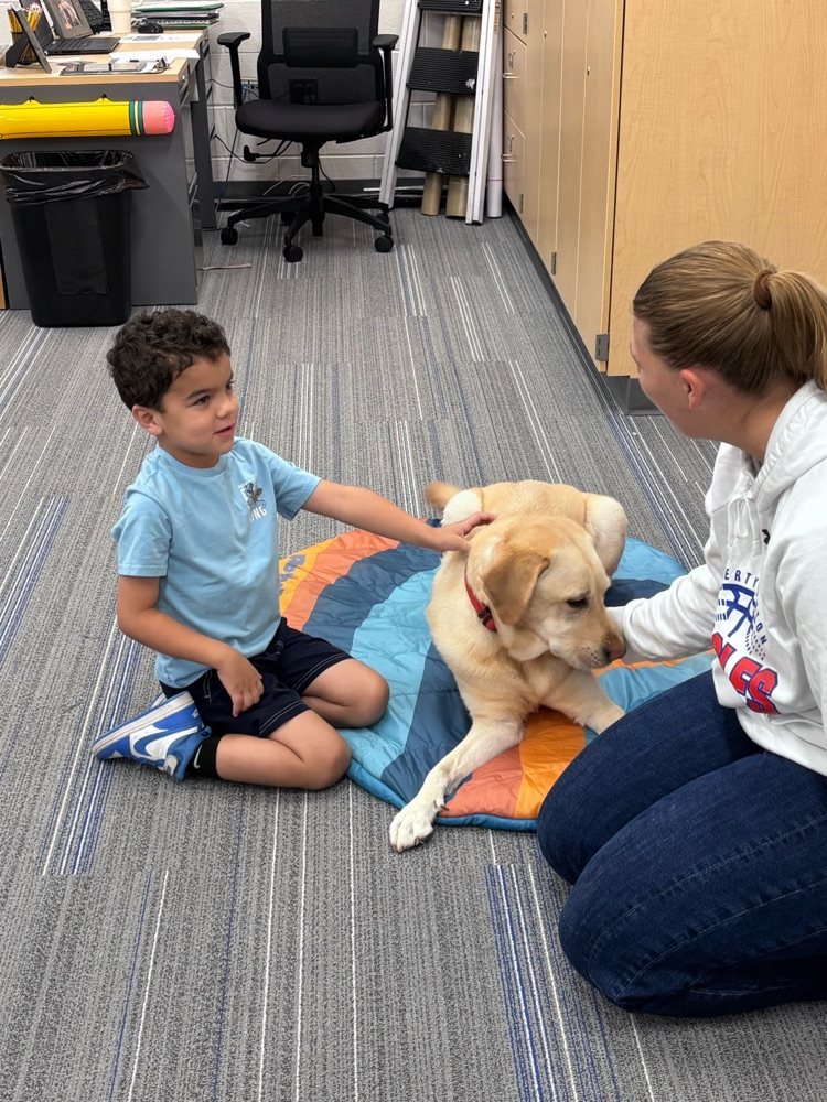 student petting dog